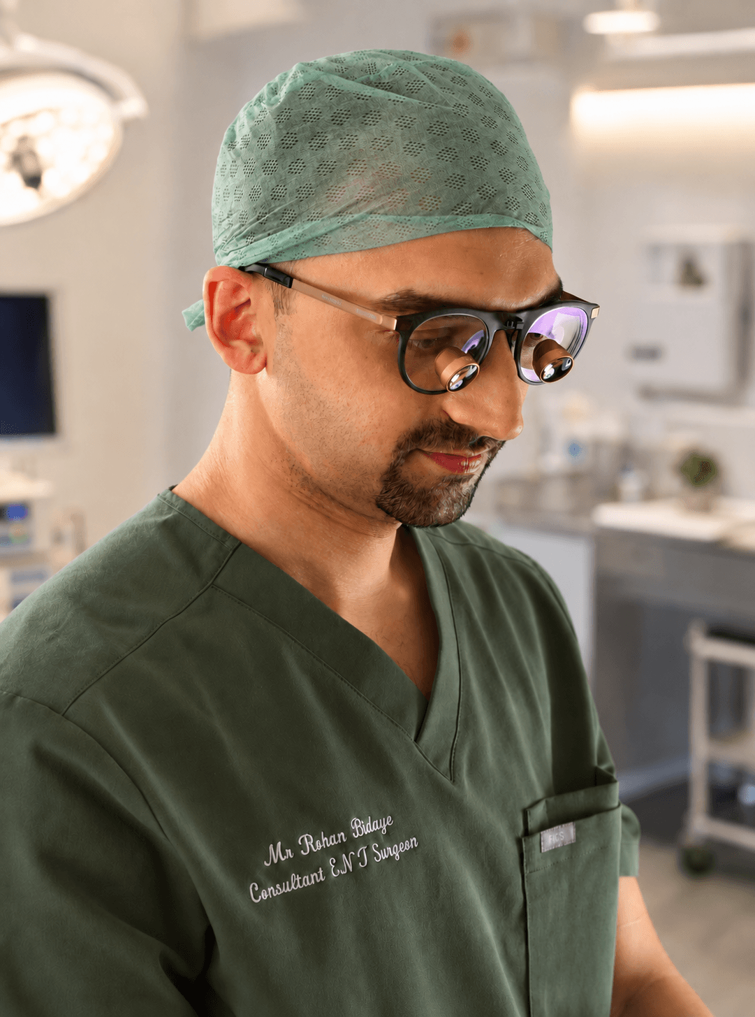 Mr Rohan Bidaye, Consultant ENT Surgeon, in theatre wearing surgical loupes